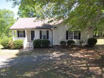 Charming one-story home featuring a cozy front porch and mature trees at 164 Sue Dr, Angier, NC 27501