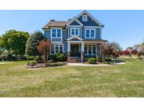 Charming two-story home featuring a welcoming front porch and beautifully landscaped front yard at 2113 Rockwall Farms Ln, Fuquay Varina, NC 27526
