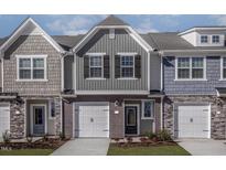 Charming two-story townhome with gray siding, brick accents, and a one-car garage at 2122 Willow Gln Dr, Graham, NC 27253