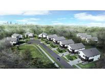 Modern community with contemporary home designs surrounded by trees with city skyline in the background at 2225 Millbank Village Ct # 101, Raleigh, NC 27610