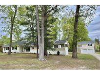 Charming single-story home featuring a covered porch, neutral paint, and mature trees at 508 & 510 Gordon St, Roxboro, NC 27573