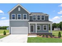Charming two-story home featuring gray siding, white trim, and a well-manicured lawn at 54 Grove Township Way, Angier, NC 27501