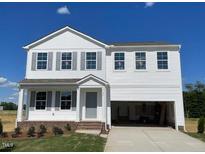 Charming two-story home with gray shutters, an attached two-car garage, and a well-maintained lawn at 59 Grove Township Way, Angier, NC 27501