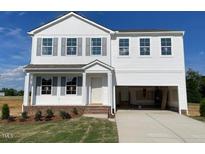 Charming two-story home with white siding, gray shutters, and an attached two-car garage at 59 Grove Township Way, Angier, NC 27501