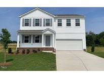 Charming two-story home featuring white siding, grey shutters, and an attached two-car garage at 59 Grove Township Way, Angier, NC 27501