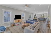Open-concept living room features a cozy seating area, natural light, and seamless access to dining and kitchen areas at 1008 Holloway St, Durham, NC 27701