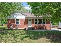 Charming brick home featuring a well-maintained lawn, quaint chairs on the porch, and mature trees at 1017 Southerlund Rd, Garner, NC 27529