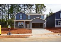Two-story home features gray siding, a two-car garage, and a covered front porch, blending modern design with comfortable living at 149 Klamath Dr, Garner, NC 27529