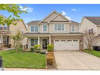 Charming two-story home with a well-manicured lawn, two-car garage, and inviting front porch at 1919 Sinclair Trce, Burlington, NC 27215