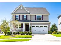 Charming two-story home featuring a two-car garage, inviting front porch, and well-maintained landscaping at 240 Liberty Star Rd, Wendell, NC 27591