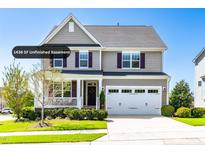Charming two-story home with a manicured front yard, complemented by a two-car garage and inviting front porch at 240 Liberty Star Rd, Wendell, NC 27591