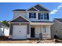 Two-story home featuring a one car garage, black shutters, and a neutral color palette at 244 Bluejay St, Clayton, NC 27520