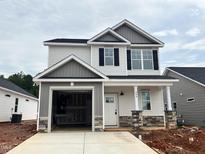 Charming new construction home with two stories, a two car garage, and stone accents on the columns at 244 Bluejay St, Clayton, NC 27520