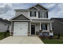 Charming two-story home featuring a two-car garage and inviting front porch at 244 Bluejay St, Clayton, NC 27520