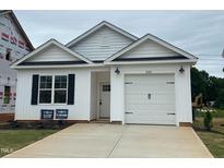 Charming new construction home with a white exterior, garage, and landscaped front yard at 250 Bluejay St, Clayton, NC 27520