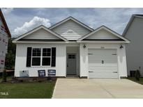 New construction with white siding, black accents, and a one-car garage at 250 Bluejay St, Clayton, NC 27520
