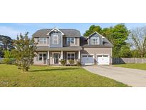 Charming two-story home with a well-manicured lawn and a two-car garage at 28 Lee Woods Dr, Clayton, NC 27520