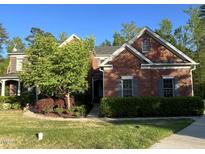 Charming two-story brick home featuring a well-manicured lawn and mature landscaping in a desirable neighborhood at 3408 Mount Pisgah Way, Cary, NC 27519