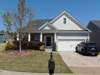 Charming home featuring a landscaped front yard, stone accents, and an attached garage at 3530 Winding Walk Ct, Raleigh, NC 27616