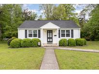 Charming home featuring a well-manicured lawn, black shutters and neatly trimmed shrubs enhancing its curb appeal at 431 Waddill St, Henderson, NC 27536