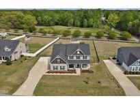 Beautiful two story home with black shutters, above ground pool and a large backyard at 46 Twelve Oaks Dr, Willow Springs, NC 27592