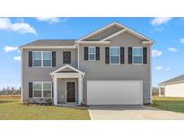 Charming two-story home featuring gray siding, a two-car garage, and a well-manicured lawn at 494 Lochalsh Dr, Gibsonville, NC 27249