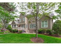 Beautiful backyard featuring a patio, lush green lawn, and well-maintained landscaping, perfect for outdoor enjoyment at 629 Peach Orchard Pl, Cary, NC 27519