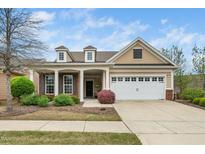 Charming single-Gathering home featuring a two-car garage, dormer windows, and manicured landscaping at 833 Gaston Manor Dr, Durham, NC 27703