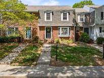 Charming brick townhouse with a well-maintained front yard and inviting curb appeal at 1020 Randolph Ct, Cary, NC 27511