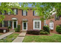 Charming brick townhome with well-maintained landscaping and black shutters at 126 W Savannah Ridge Rd, Holly Springs, NC 27540