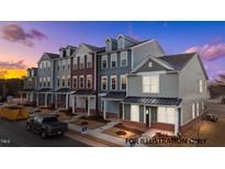 Charming multi-colored townhomes, with well-maintained landscaping and inviting entrances, at dusk at 133 Pearl St # 7, Garner, NC 27529