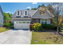 Charming home features a two-car garage, dormer windows, craftsman trim and a well-manicured lawn at 2008 Stanwood Dr, Apex, NC 27502