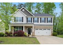 Charming two-story home with well-maintained landscaping and a two-car garage at 226 Fair Oaks Ct, Mebane, NC 27302