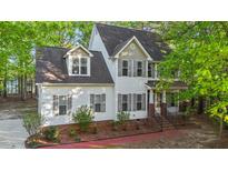 Beautiful two-story home with white siding, grey shutters, and lush landscaping at 286 Trillium Way, Clayton, NC 27527