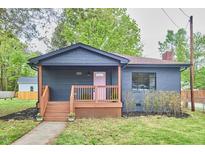 Charming single-story home with inviting porch and delightful pink front door at 4513 Denfield St, Durham, NC 27704