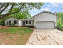 Charming two-story home featuring a two-car garage and a beautifully landscaped front yard at 5604 Groomsbridge Ct, Raleigh, NC 27612