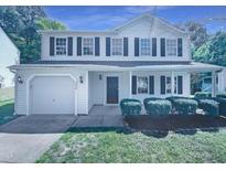 Charming two-story home with a front yard, attached garage and dark shutters at 5828 Brambleton Ave, Raleigh, NC 27610