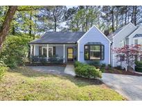 Charming blue home with a cozy front porch and lush landscaping at 6 Landover Ct, Durham, NC 27713