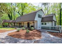 Charming home exterior with covered porch, stone pathway, fresh mulch and a cozy, inviting ambiance at 831 Healey Ln, Durham, NC 27705