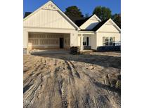 New construction home featuring a two-car garage and white siding, with a dark roof at 1008 Peedin Rd, Selma, NC 27576