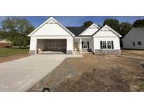 Charming new home with a welcoming entrance and attached garage, perfect for modern living at 1008 Peedin Rd, Selma, NC 27576