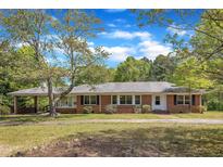 Charming brick home with a covered carport and beautiful landscaping at 1213 Walnut St, Cary, NC 27511
