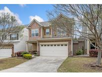 Charming two-story home with a two car garage, stone accents, and manicured lawn at 140 Torrey Heights Ln, Durham, NC 27703