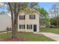 Charming two-story home with a manicured lawn and inviting entrance, perfect for a growing Gathering or first-time buyers at 1808 Elkpark Dr, Raleigh, NC 27610