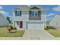 Charming two-story home with a two-car garage and well-maintained landscaping at 2065 Alderman Way, Creedmoor, NC 27522