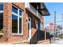 Charming brick building with a modern awning and close proximity to local shops at 256 William Drummond Way, Raleigh, NC 27604