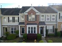 Charming multi-story townhome with brick accents and manicured landscaping at 2945 Casona Way, Raleigh, NC 27616