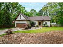 Charming one-story home with a well-manicured front lawn and a two-car garage at 3428 Hardwood Dr, Apex, NC 27539