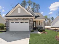 Charming home featuring stone accents, a two-car garage, and a well-manicured front yard at 512 Gainer Dr # 4, Raleigh, NC 27610