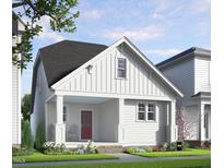Charming exterior elevation of a two-story home with a welcoming front porch and landscaped yard at 528 Folk Song Way, Wendell, NC 27591